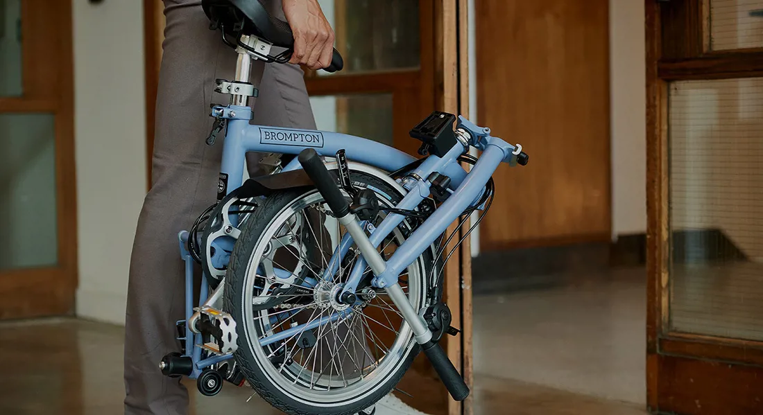 Man carrying a folded bicycle